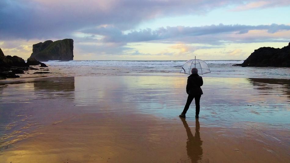 man with umbrella on beach