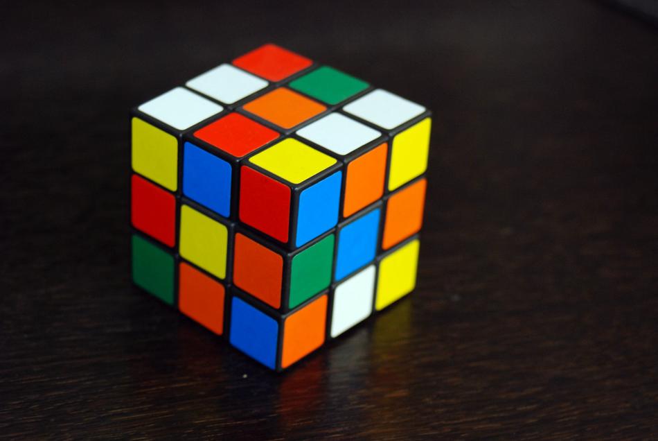 multicolored rubik cube on black background