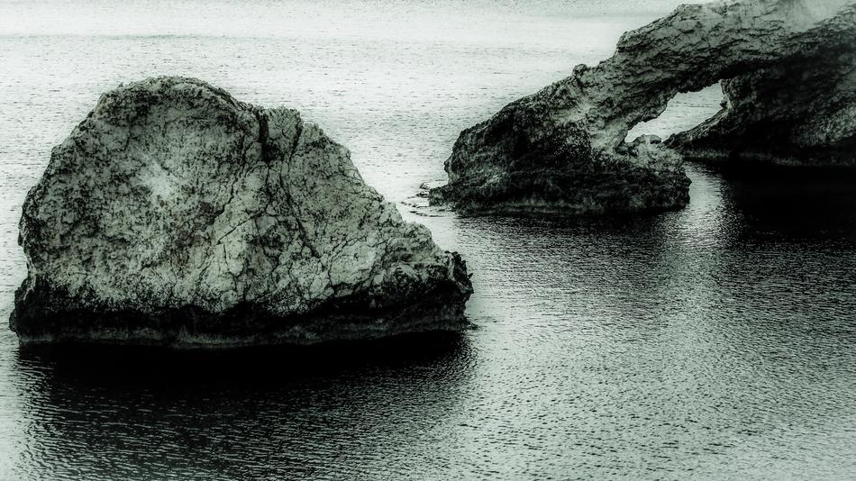 A large stone with a sea landscape