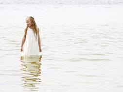 Girl in white Dress is Standing in water