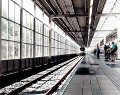 Passengers waiting on platform of Railway station