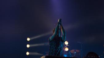 male singer on stage at back light