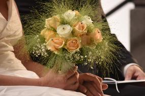 The bride has a large bouquet of flowers