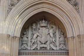 ornate Coat Of Arms, stone carving on facade of historical building, uk, england, london