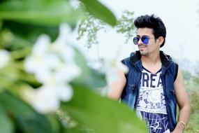 young man in blue sunglasses outdoors