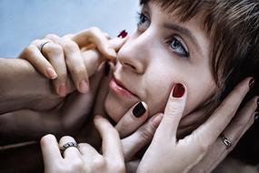 female Hands at young girl face