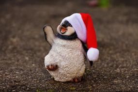 toy Penguin in Santa hat on ground