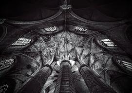 black and white shot from a low angle of a column and a window