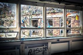 broken glass windows in an abandoned factory