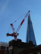 construction crane and glass skyscraper in London