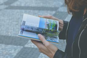 open book in hands of person
