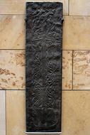 a long, black, patterned stone