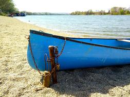 a boat tied up with a rope on the beach