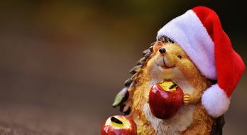 funny figurine of a hedgehog wearing a santa claus hat