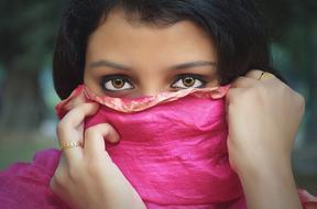 sensual woman covered by pink fabric