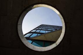 view of a building with a glass facade against the sky