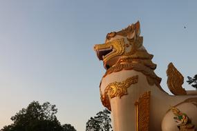 Beautiful golden and white statue near Swedagon Pagoda in Yangon, Myanmar