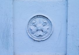 ornament on blue wall close up