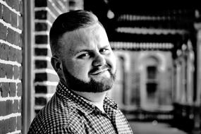 black and white photo portrait of a young man with a beard