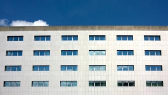 Building at blue sky with white clouds on background, in Roissy, France