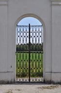 iron entrance gate in a white wall