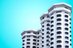 Beautiful, white high-rise building, at blue, gradient sky on background