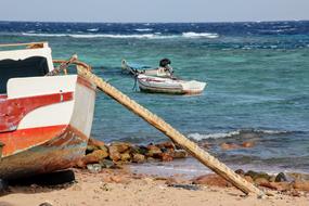 Boats on beach and on water, nobody