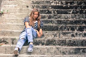 photo of a girl in jeans on the steps