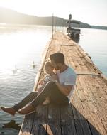Father with the child, on the beautiful pier, in sunlight