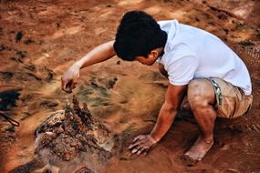 Boy plays with sand castle