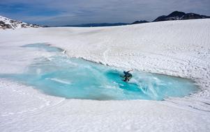 Person, snowboarding on the ice, on the beautiful, snowy mountain