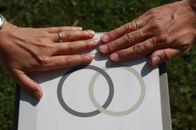 the couple's hands with the ring