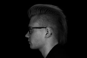 profile of young man in Eyeglasses at darkness