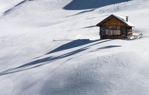 chalet on a snowy slope in the mountains