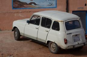 white retro car near the wall in Morocco