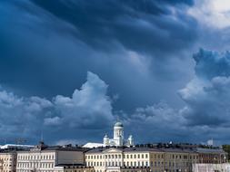 white church in old City beneath dark stormy Clouds