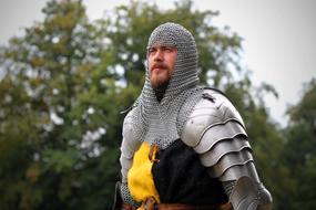 young man in medieval knight armor outdoor