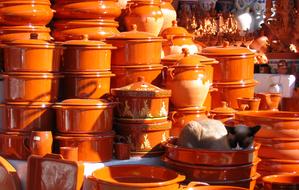 cat sleeps in a clay pot in the market