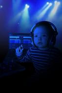 Child in headphones at darkness