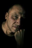 low key portrait of mature serious man
