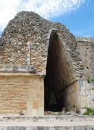 Colorful Maya vault in Uxmal, Yucatan, Mexico, under the blue sky with white clouds