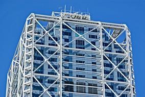 Building, in blue and white colors in Barcelona, Spain, at blue sky on background