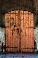 closed Old Wooden double Door in stone wall