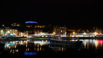 picturesque waterfront of old Town with colorful lights at night, uk, Scotland, Oban