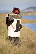 Woman taking photo of scenic Landscape