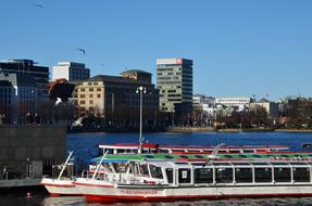 Colorful ship on the water, near the colorful buildings in Hamburg, Germany