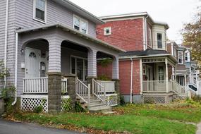 row of townhouses beside of road at indian summer, Canada