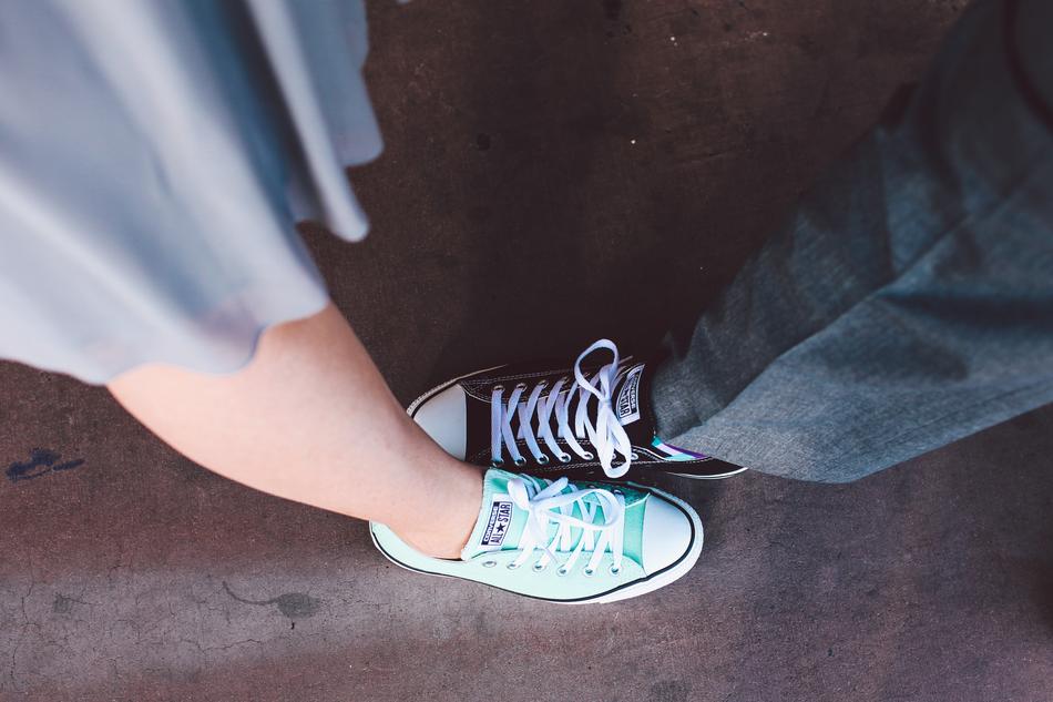 Mint and black All Star Converse on the feet of people