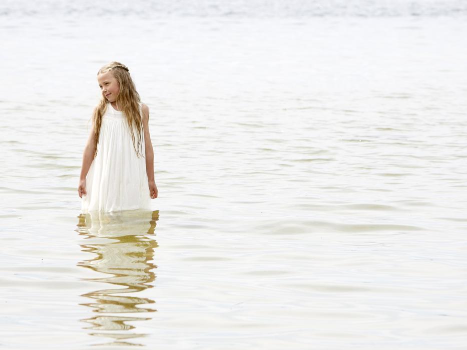Girl in white Dress is Standing in water