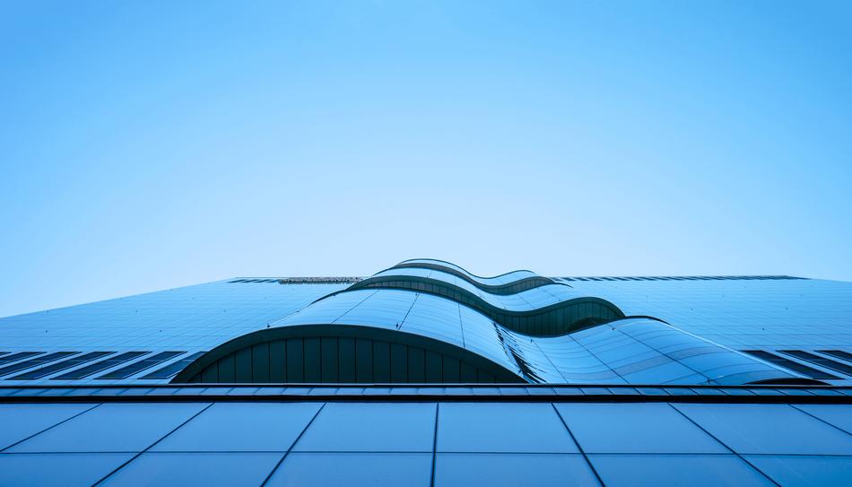 Low angle view of contemporary blue glass facade